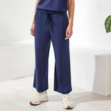 Person wearing navy blue pants with a white background