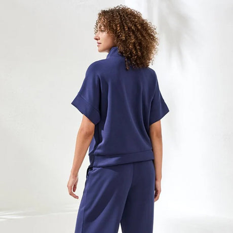 Woman wearing a blue outfit against a white background