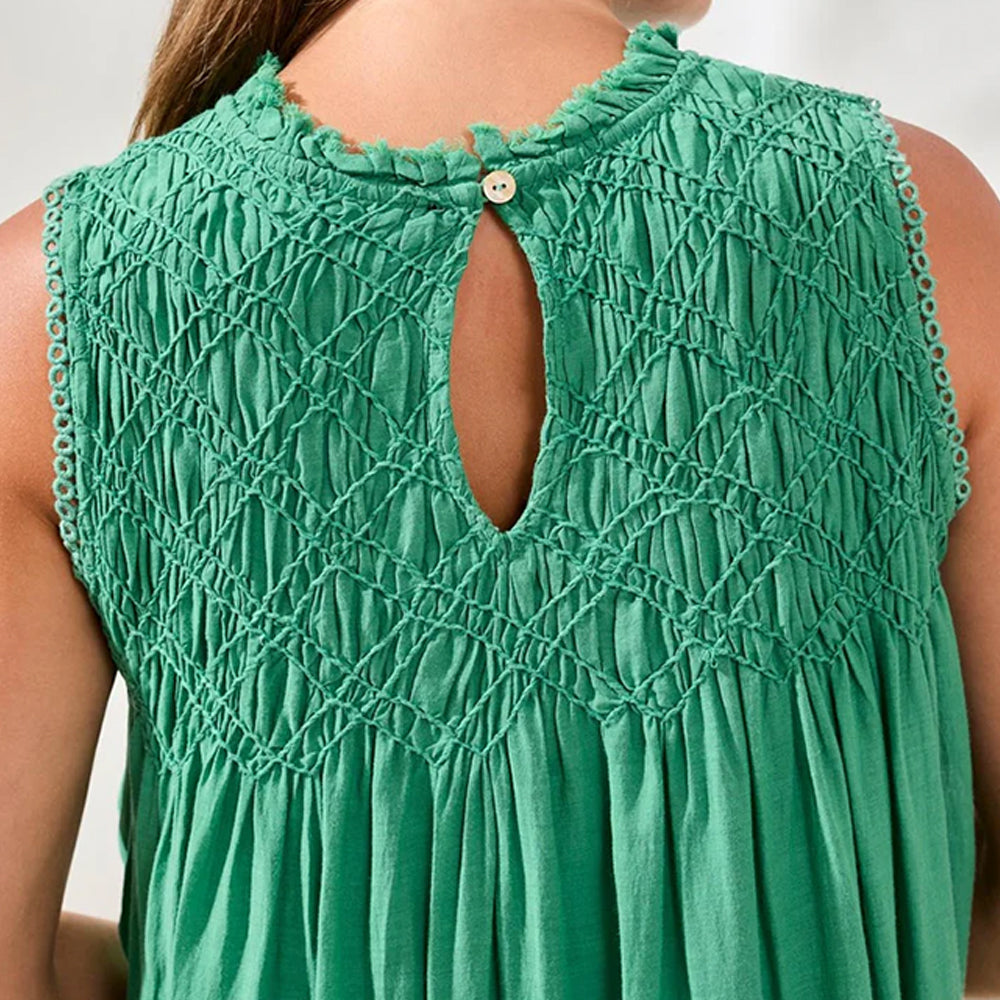 Green sleeveless top with textured pattern on a neutral background