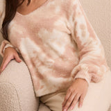 Lady sitting on couch in cream sweater