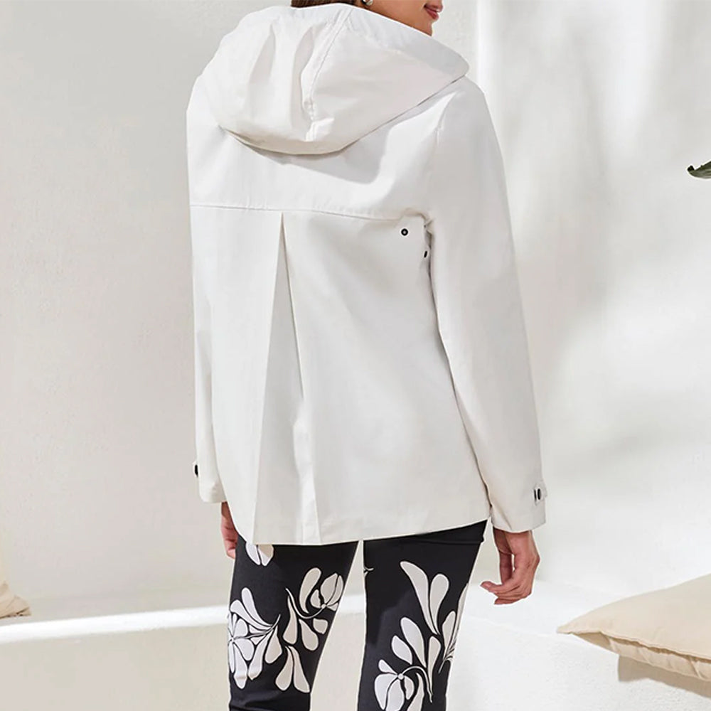 Person wearing a white coat with a neutral background