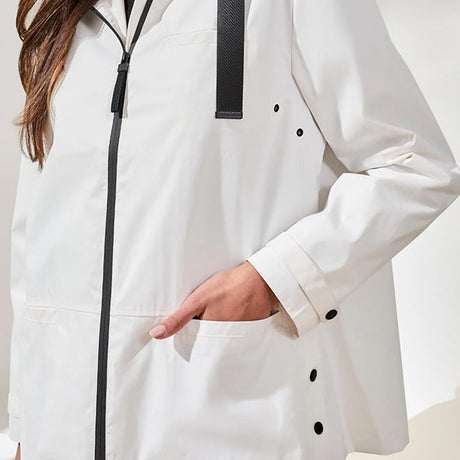 White coat with black buttons and zipper on a plain background