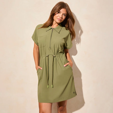 A woman modeling a green short sleeve zip polo dress with a waistband drawcord.