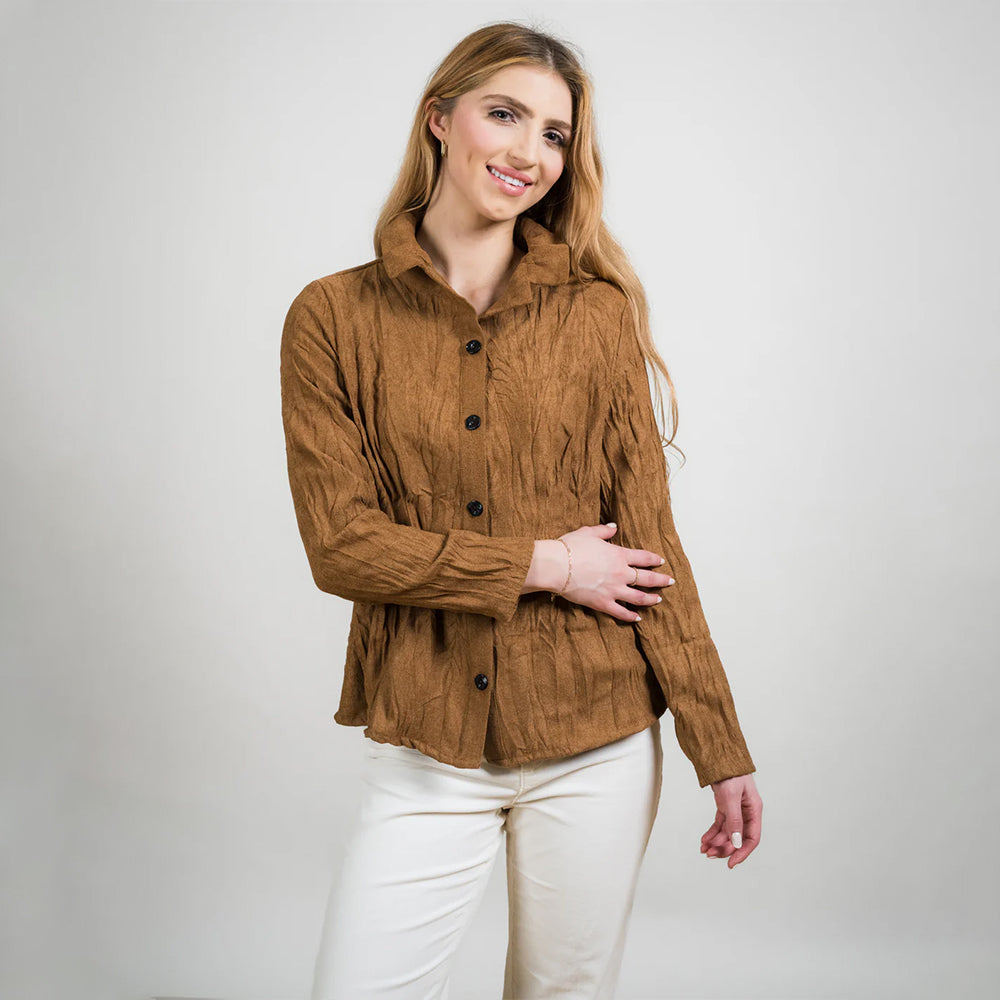 Woman wearing a brown corduroy jacket against a white background