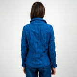 Person wearing a blue textured jacket on a white background