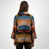 Person wearing a colorful patterned shirt on a white background