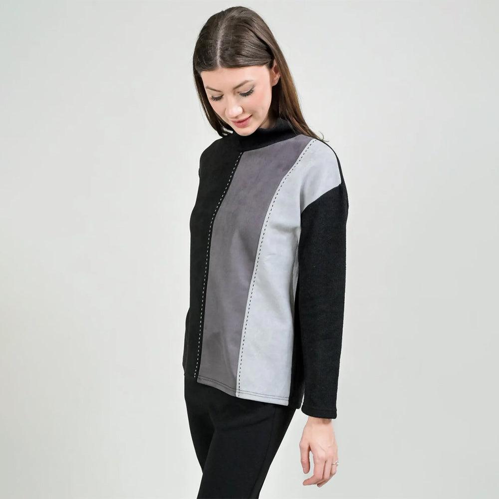 Woman wearing a black and gray color-blocked top on a white background