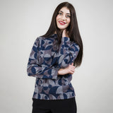 Woman wearing a patterned sweater against a plain background