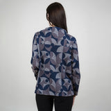 Person wearing a patterned jacket on a plain background