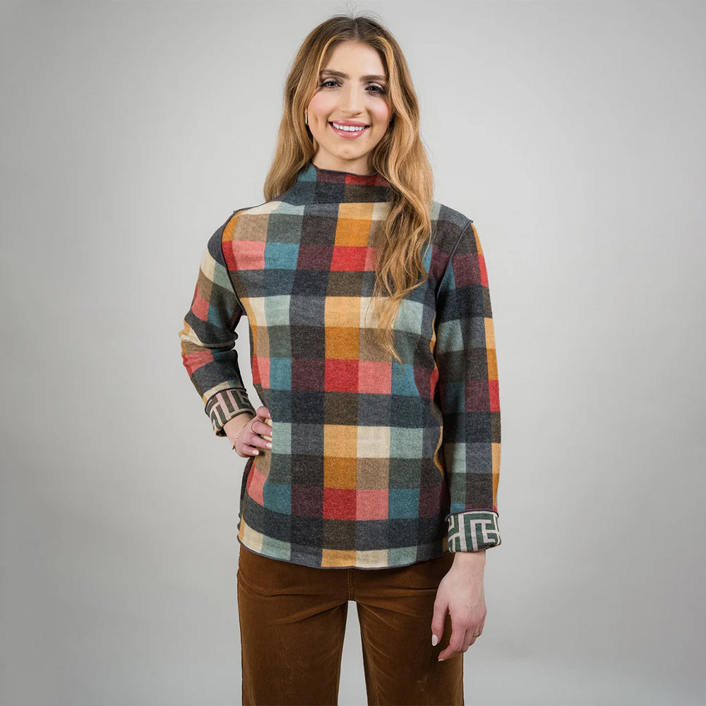 Woman wearing a plaid shirt with a gray background