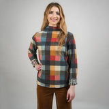 Woman wearing a plaid shirt with a gray background