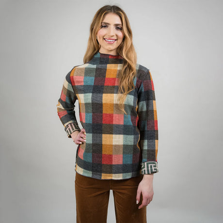 Woman wearing a plaid shirt with a gray background