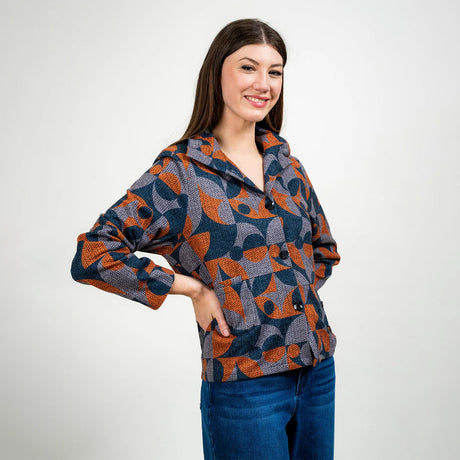 Woman wearing a patterned sweater against a white background