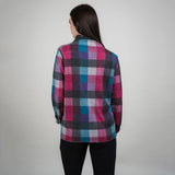Person wearing a colorful plaid shirt against a plain background