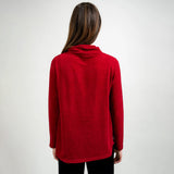 Person wearing a red sweater with a white background