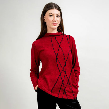 Woman wearing a red sweater with black pattern on a white background