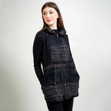 Woman wearing a black and gray patterned vest on a white background