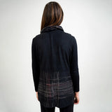 Person wearing a dark gray jacket with plaid pattern on a white background