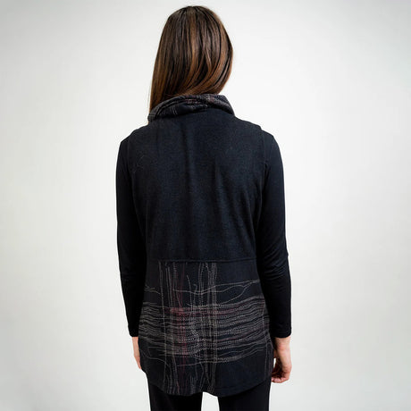 Person wearing a dark gray jacket with plaid pattern on a white background