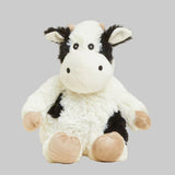 Plush cow toy on a gray background