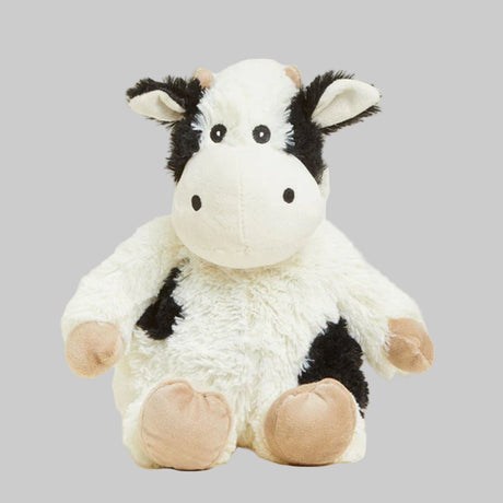 Plush cow toy on a gray background