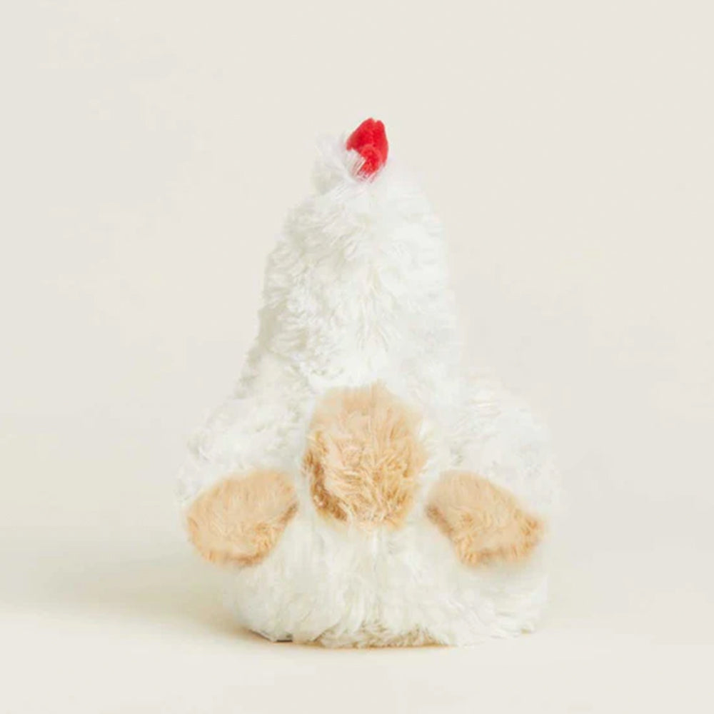 Plush toy resembling a chicken with a red comb on a light background