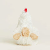 Plush toy resembling a chicken with a red comb on a light background