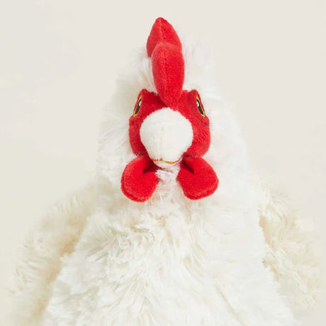 Red and white plush toy on a white background