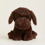 Brown plush dog toy on a beige background