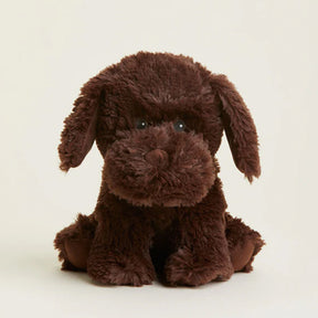 Brown plush dog toy on a beige background