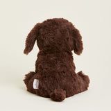 Brown plush dog toy on a light beige background