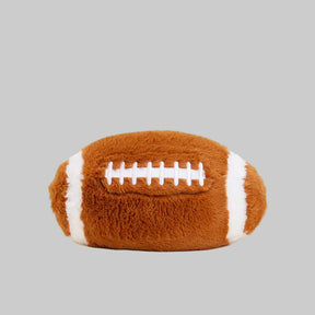 Plush football toy on a gray background