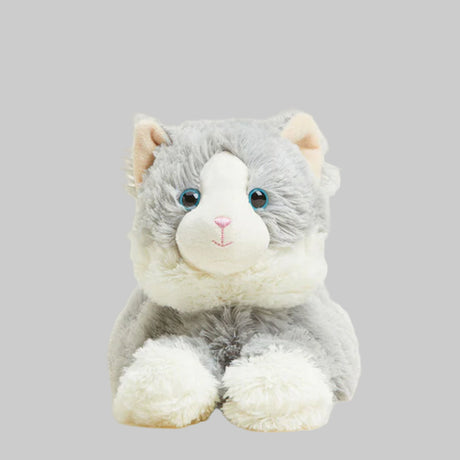 Plush toy cat with gray fur and blue eyes on a gray background
