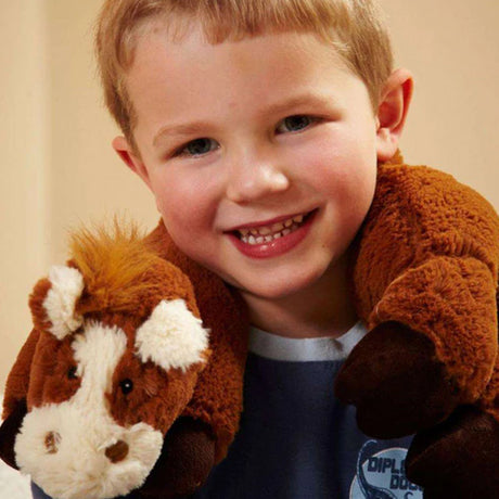Child holding a plush horse toy with a neutral background