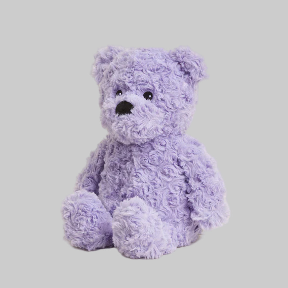Purple teddy bear on a light gray background