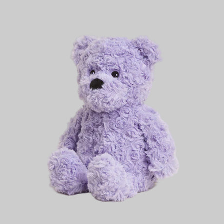 Purple teddy bear on a light gray background