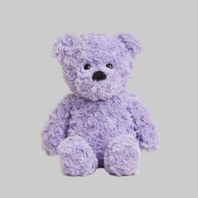 Purple teddy bear on a light gray background